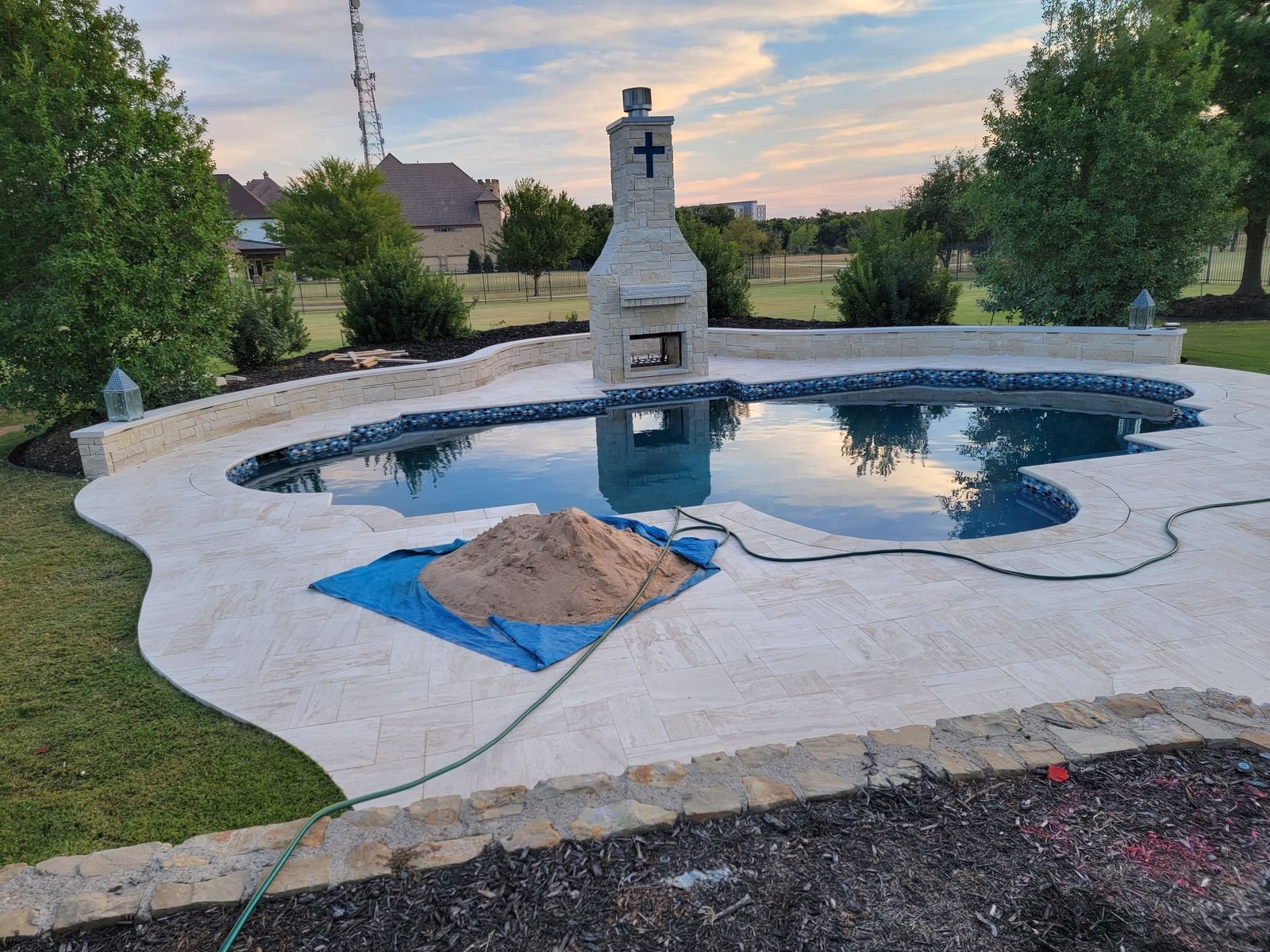 new-backyard-pool-installation-with-fireplace-and-landscaping